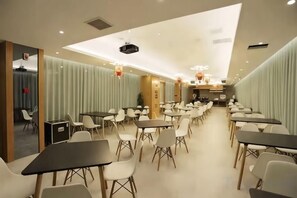 A conference room with tables and chairs arranged for meetings. - Midor Hotel (Honggutan Wanda Plaza) (Nanchang)