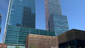 A modern building with a glass facade and a sign that reads "BOSS". - Joyous Hotel (Shanghai)
