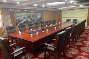 A conference room with a long table, chairs, and a carpeted floor. - Wentinghu Hotel (Chengwu)