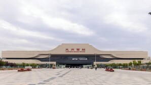 A large, modern building with a flat roof and a wide entrance.