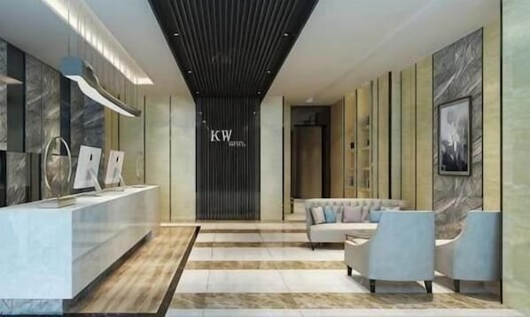A reception area with a reception desk, seating area, and a wall with the initials 'KW'. - Kaiwang Hotel (Nanjing Mingguo Subway Station Military General Hospital) (Nanjing)