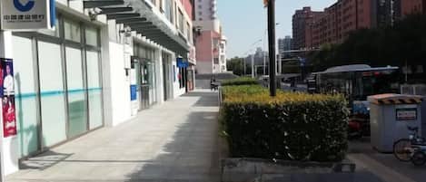 A street with a building featuring a sign for the China Construction Bank.