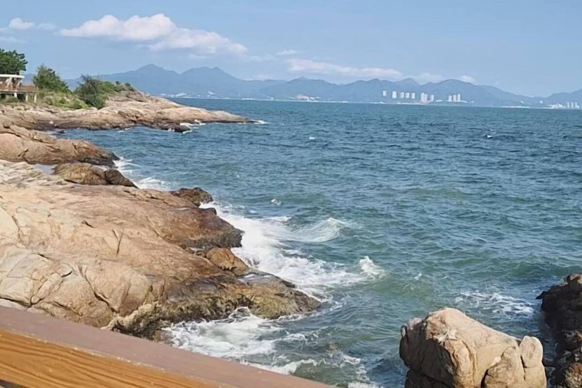 A coastal view with rocky terrain and a body of water.