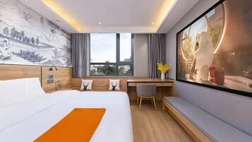 A modern hotel room with a large bed, a desk, a window with a view, and a mural on the wall.