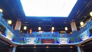 A traditional Chinese building with a tiled roof and lanterns.