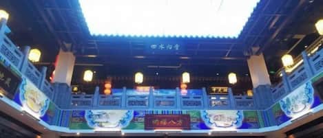 A traditional Chinese building with a tiled roof and lanterns.