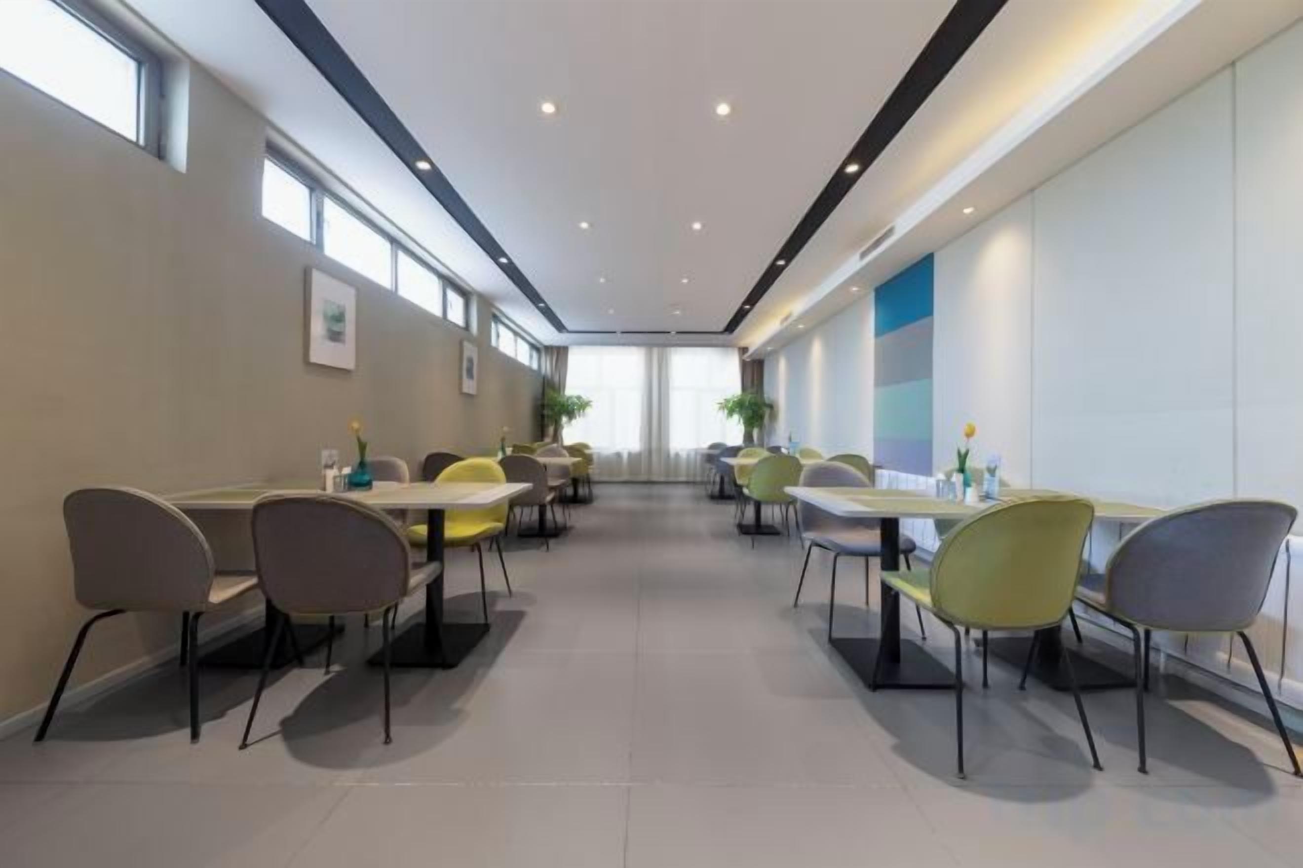 A conference room with tables and chairs, large windows, and a modern design.