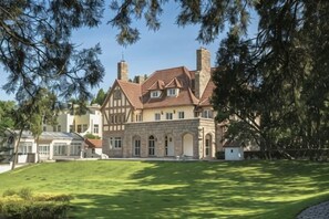 A large, two-story house with a prominent chimney, a well-maintained lawn, and a clear sky. - Residential quarters in Yinqi mountain, Qingdao (Qingdao)