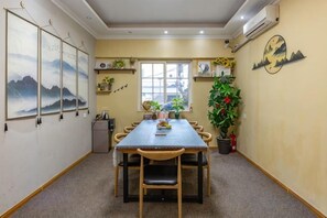 A conference room with a long table, chairs, and a window. - Residential quarters in Yinqi mountain, Qingdao (Qingdao)
