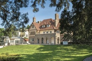 A large, two-story house with a prominent chimney, a well-maintained lawn, and a clear sky. - Residential quarters in Yinqi mountain, Qingdao (Qingdao)