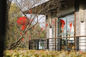 A building with a traditional architectural style, featuring a balcony with a railing. - Yingdong Resort (Shanghai)