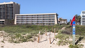 A beachfront hotel with multiple balconies and a sandy beach area. - Breath-taking Ocean Views, Pool & Hot Tub. 5th Floor Beachfront Views! (South Padre Island)