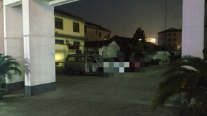 A parking area with a van parked near a building entrance. - chezhan hotel (Shanghai)