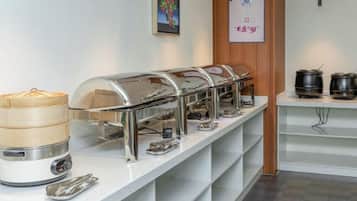 A buffet setup with multiple self-service stations, including a variety of food containers and utensils.