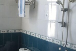 A bathroom with a shower, a towel rack, and a toilet. - Dongzhu Hostel (Shanghai)