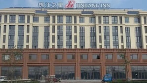 A multi-story building with a prominent signage for 'JINJANG INN.' - Jinjiang Inn (Tianjin)