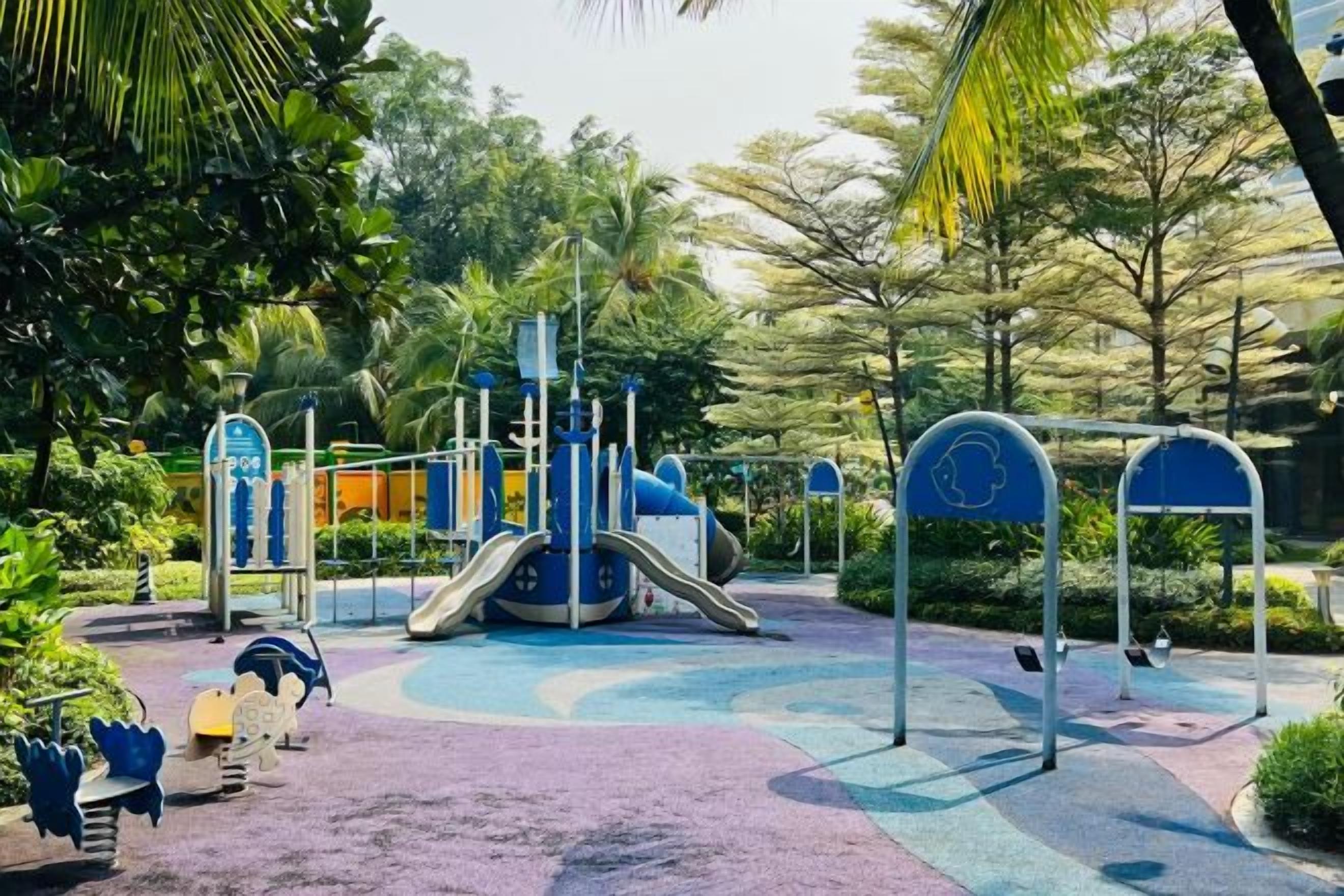 A playground with a slide, climbing structures, and swings.
