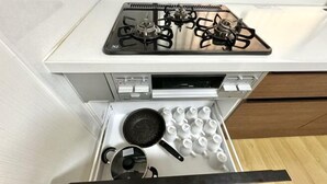 A kitchen with a stove, a drawer with utensils, and a pot. - Japanese Cottage Kenkou (Osaka)