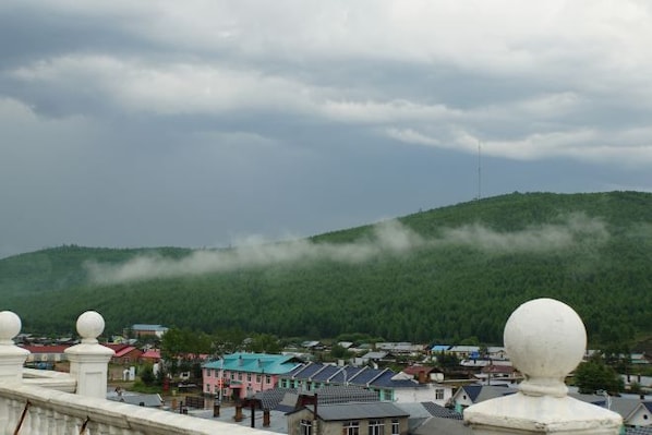 A town with buildings and a hill in the background.