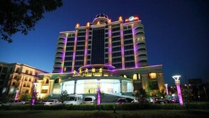 A multi-story hotel with a prominent sign reading "GOLD EAGLE HOTEL". - Golden Eagle Hotel (Zhoushan)
