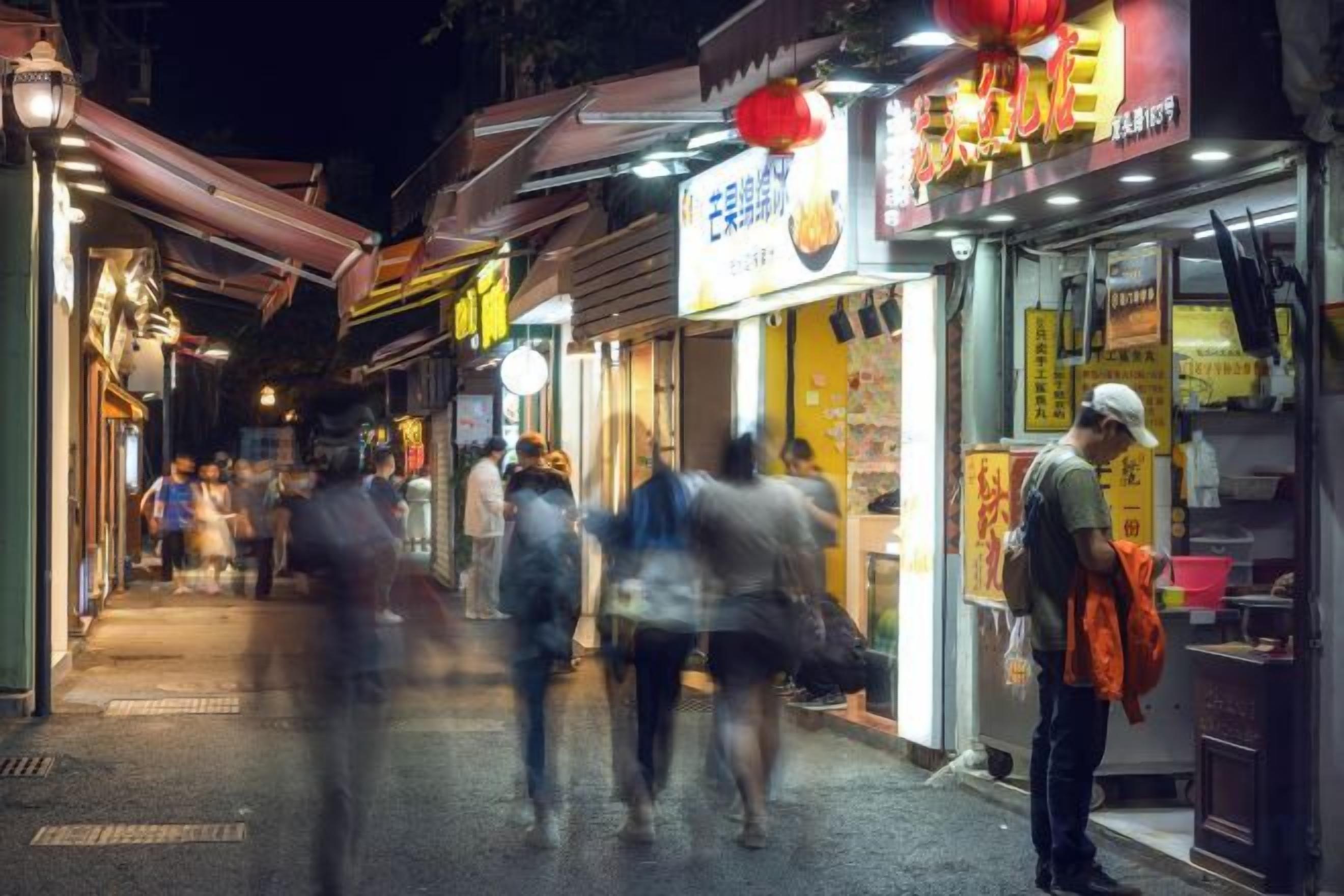 A street with shops and people walking.