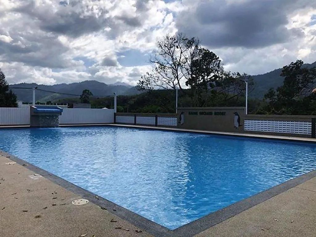 A swimming pool with a view of mountains in the background.