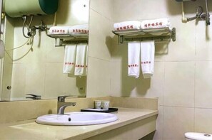 A bathroom with a sink, mirror, towel racks, and a toilet. - Jingxuanlou Hotel(near the great wall) (Qinhuangdao)