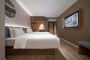 A modern hotel room with a large bed, a desk, and a television mounted on the wall. - Nayuan Hotel (A.D. Times City) (Taiyuan)