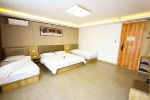 A hotel room with two single beds, a wooden wardrobe, a flat-screen TV, and a ceiling light. - Jinhui Fashion Hotel (Baicheng)