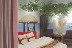 A room with a bed, a chair, a table, a thatched roof structure, and a large tree. - Huashu Hotel(Shanghai Yexie Store) (Shanghai)