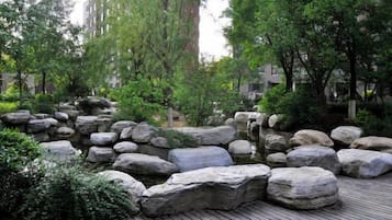A landscaped garden with large rocks and trees.