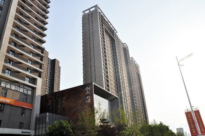 A high-rise building with multiple floors, large windows, and a modern architectural design.