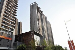 A high-rise building with multiple floors, large windows, and a modern architectural design. - Taiyuan Live Service Apartment (Taiyuan)