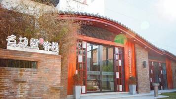A building with a traditional architectural style, featuring a brick facade and a tiled roof.