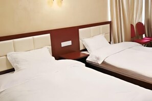 A hotel room with two beds, a wooden headboard, a nightstand, and a red chair. - Nanjing Ruijia Hotel (Yuhuatai Scenic Area Branch) (Nanjing)