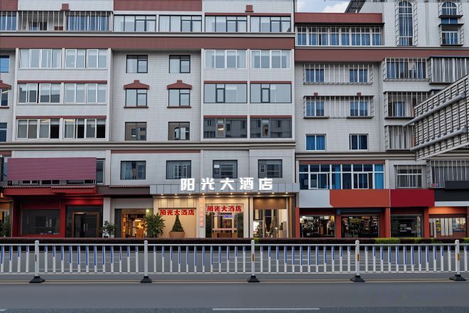 A multi-story hotel with a prominent signage for 'Sunshine Hotel.'