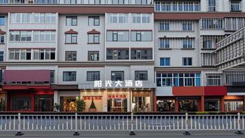 A multi-story hotel with a prominent signage for 'Sunshine Hotel.'