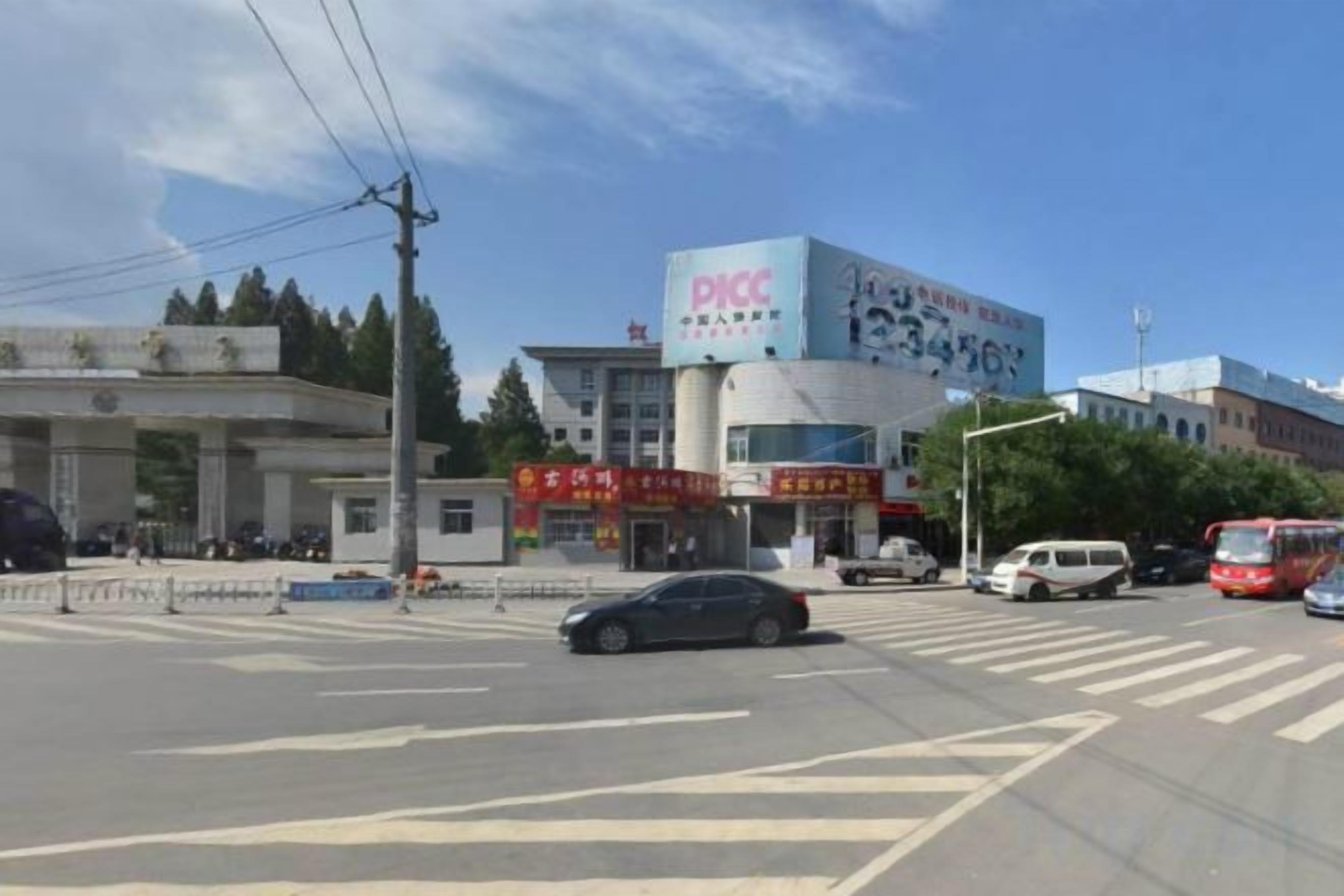A multi-story building with signage for DICC and a large sign with Chinese characters.