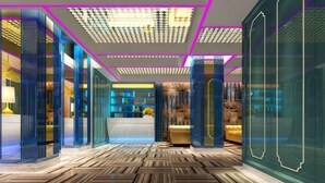 A modern hotel lobby with a patterned floor, glass partitions, and a reception area. - Mianyang 4D Future Hotel (Gaoshui Branch) (Mianyang)