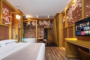 A hotel room with a bed, a desk, a television, and a bathroom with a shower and a mirror. - Mianyang 4D Future Hotel (Gaoshui Branch) (Mianyang)