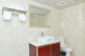 A bathroom with a white sink, a toilet, a mirror, and a towel rack. - Baishuitang Hotel (Jiashan)