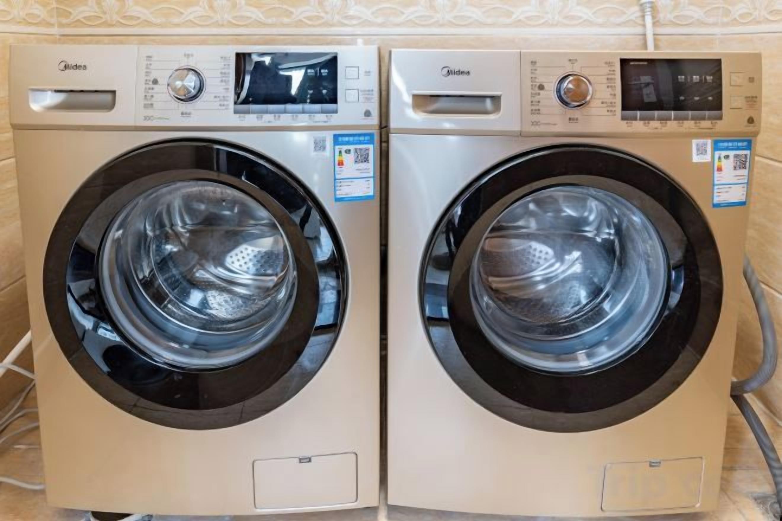 Two front-loading washing machines with control panels, placed side by side.