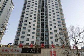 A high-rise building with multiple floors, featuring a commercial ground floor with signage. - Hotel of The Future (Jiefang Road) (Wulian)
