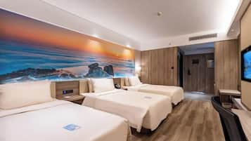 A hotel room with two beds, a TV, a painting on the wall, and a wooden floor.