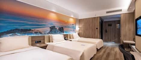Quarto de hotel com duas camas, televisão, um quadro na parede e piso de madeira.