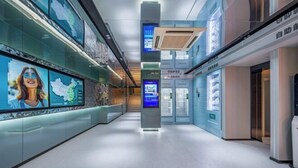 A modern indoor corridor with digital displays, a glass wall, and a clean, minimalist design. - MAXACCOM Future Hotel (Shanghai Hongqiao Airport Xinzhuang, Qibao) (Shanghai)