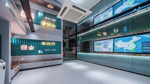 A modern interior with a seating area, digital displays, and a map. - MAXACCOM Future Hotel (Shanghai Hongqiao Airport Xinzhuang, Qibao) (Shanghai)