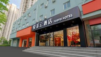A hotel with a modern facade, large windows, and a prominent entrance.