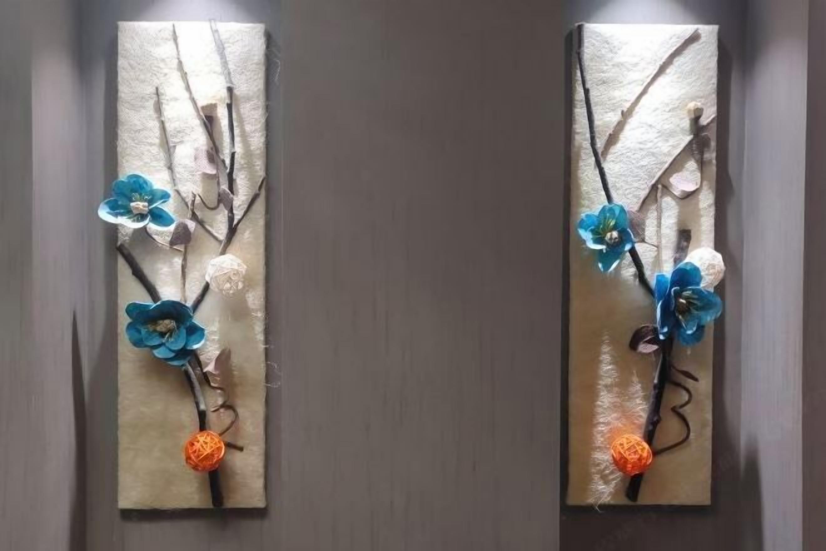 Two vertical artworks with branches and flowers.