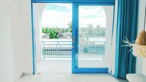 A room with a view of a balcony and outdoor area. - Ivy Canggu (Munggu)
